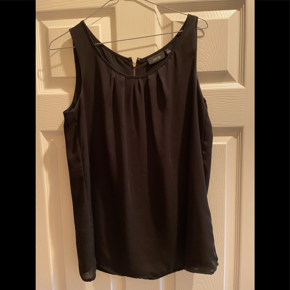 Black sleeveless blouse with gold zipper on back.